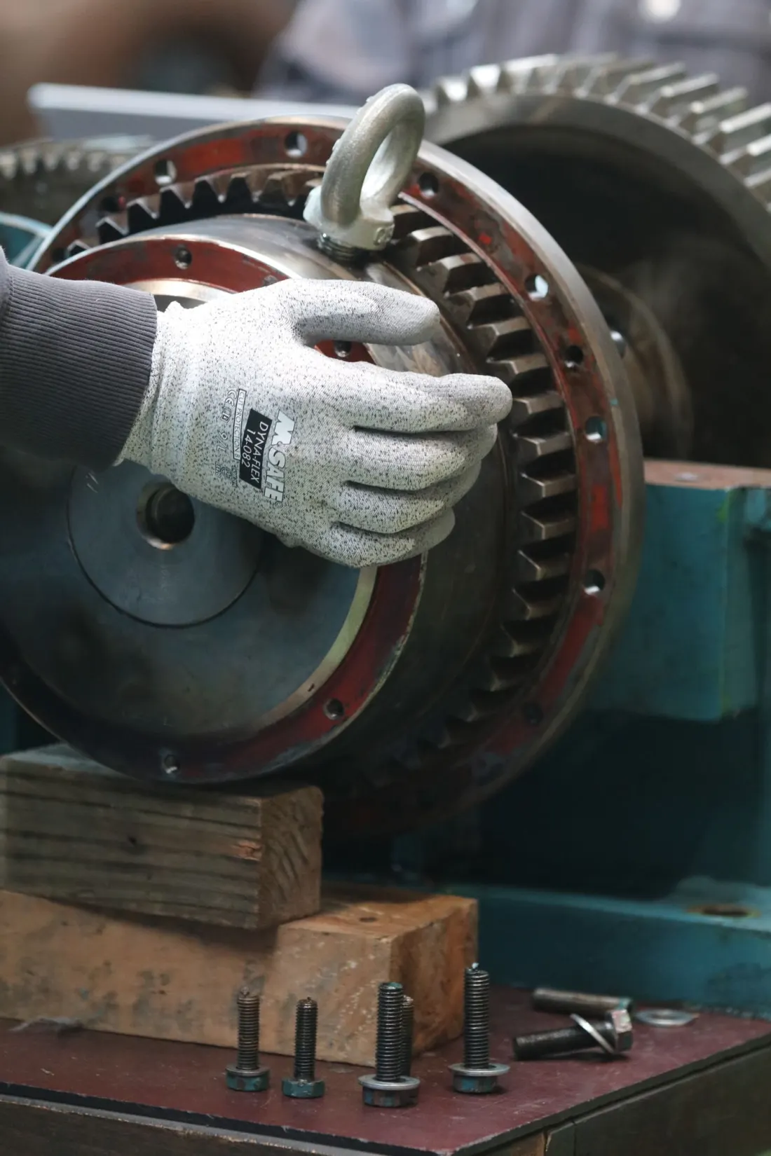 Technician inspecting a large industrial gear assembly