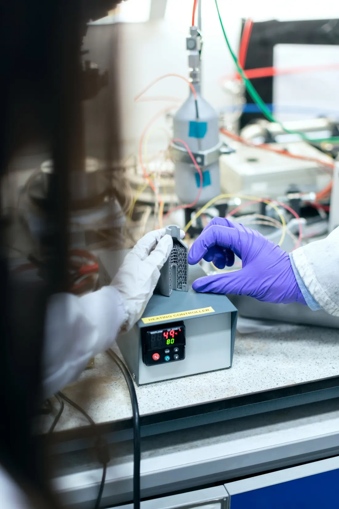 Engineers testing a component under controlled laboratory conditions